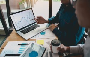 Two gentlemen are reviewing earned value graphics